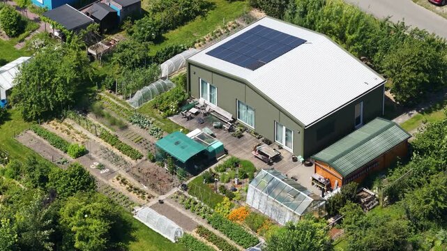 Aerial view of an ecovillage in Almere, showing sustainable housing, urban farming, solar panels, self sufficient living and renewable energy in the Netherlands.