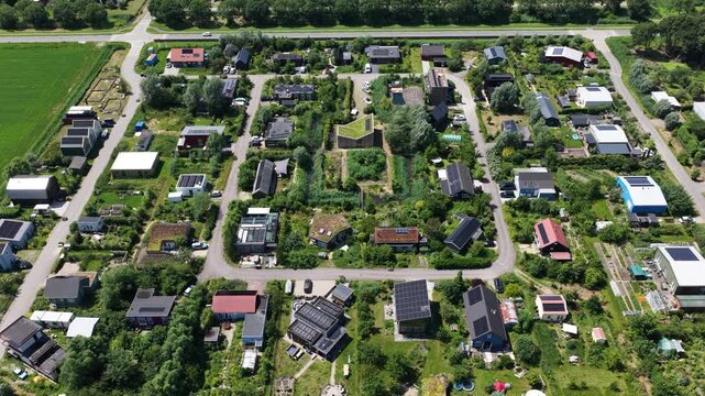 Aerial view of an ecovillage in Almere, showing sustainable housing, urban farming, solar panels, self sufficient living and renewable energy in the Netherlands.
