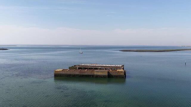 Aerial view of the historic Phoenix caissons at Schelphoek, showing Dutch flood defense heritage, dike repair and the former 1953 disaster site in Zeeland.