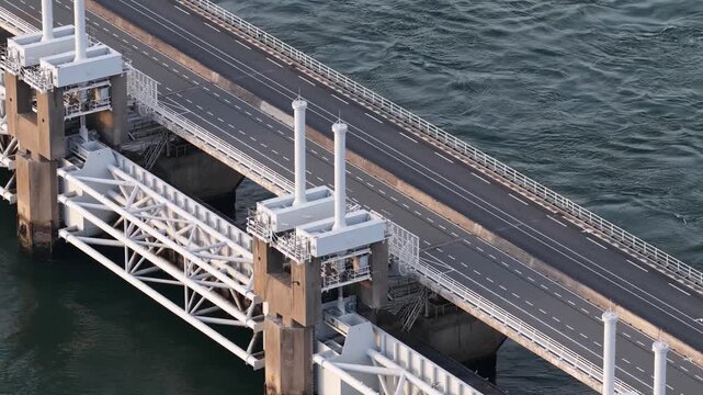 Aerial view of the Oosterscheldekering, showing the Dutch storm surge barrier, Delta Works engineering, flood protection and coastal road infrastructure.