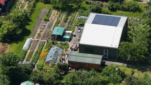 Aerial view of an ecovillage in Almere, showing sustainable housing, urban farming, solar panels, self sufficient living and renewable energy in the Netherlands.