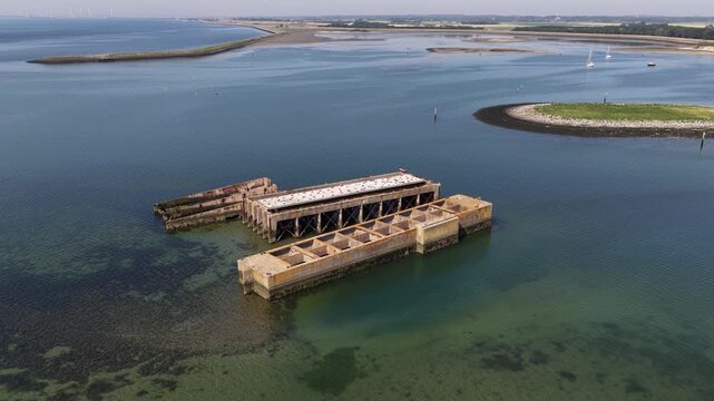 Aerial view of the historic Phoenix caissons at Schelphoek, showing Dutch flood defense heritage, dike repair and the former 1953 disaster site in Zeeland.