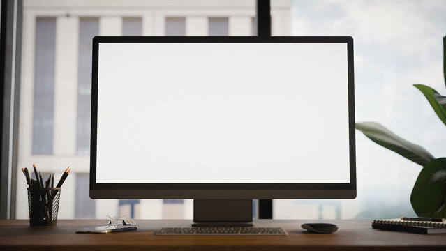 Modern Computer Blank Screen Mockup on Office Desk With Window View
