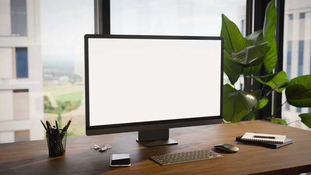 Modern Computer Blank Screen Mockup on Office Desk With Window View