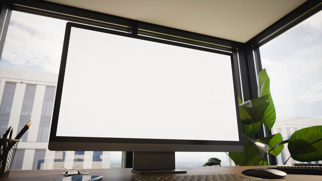 Modern Computer Blank Screen Mockup on Office Desk With Window View