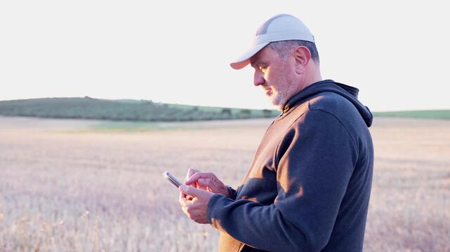 Farmer using smart phone in a field