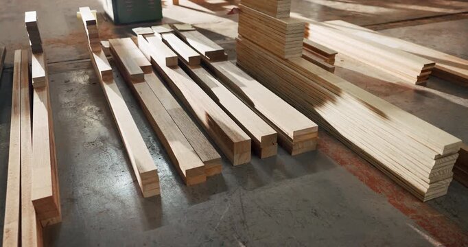 Carpentry, industry and lumber in empty factory for craftsmanship, manufacturing or production. Creativity, material and timber with wood in warehouse interior for furniture business or storage
