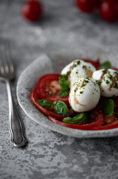 Close-up of fresh tomato mozzarella Caprese salad with basil