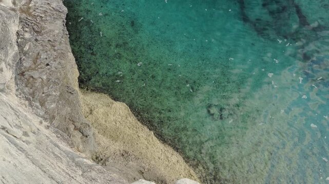 Aerial view of the rugged limestone coastline and turquoise waters surrounding the Clifton Memorial in Nassau, New Providence, The Bahamas.