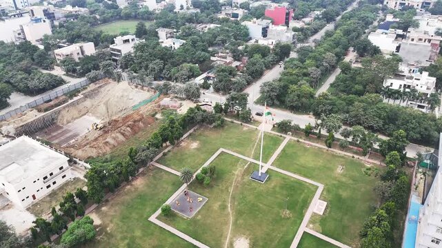 Aerial view of a park with a flagpole and green lawns in Noida, Uttar Pradesh, India.