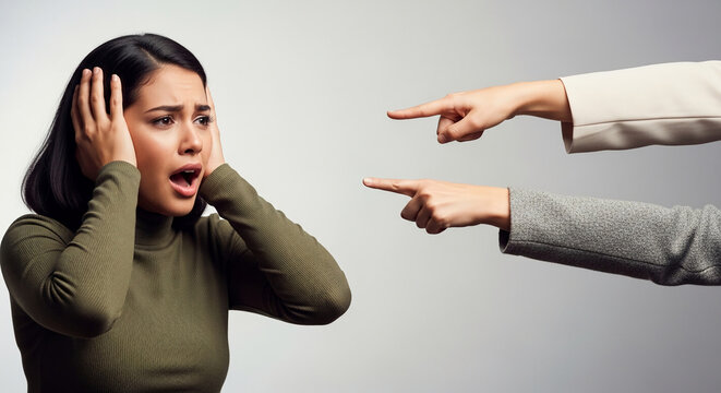 Young woman covers ears in distress as fingers point accusatorily, symbolizing pressure, judgment, and anxiety, a powerful concept representation