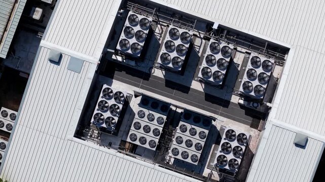 Aerial view of industrial data center ventilation cooling fans installed on a metal roof in Redditch, England, United Kingdom.
