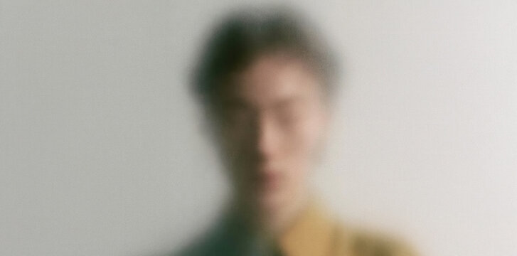 Abstract Blurred Portrait of a man Behind Textured Translucent Glass