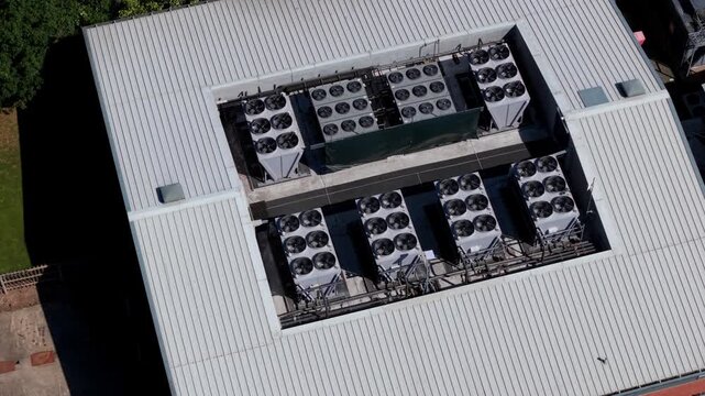 Aerial view of industrial cooling fans and ventilation units on a data center roof in Redditch, England, United Kingdom.