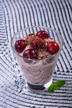 Chocolate cherry trifle dessert with mint in glass