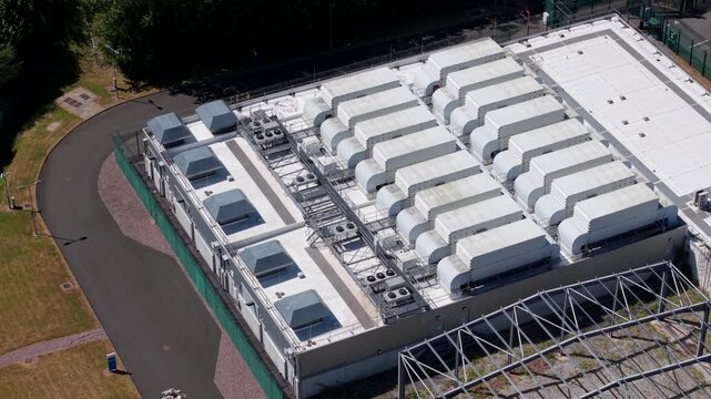 Aerial view of data centre with rows of server ventilation units on the roof in Birmingham, England, United Kingdom.