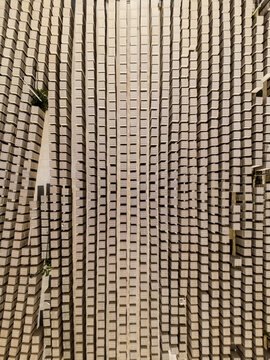 Aerial view of a brick factory with rows of stacked clay bricks arranged in a precise geometric pattern in Merida, Yucatan, Mexico.