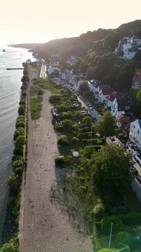 Aerial view of Elbstrand Blankenese showing the sandy beach, river Elbe, and residential houses along the hillside in Hamburg, Hamburg, Germany.