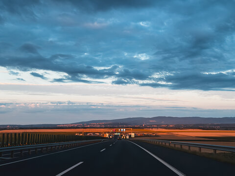 Cinematic road trip perspective under dramatic moody storm clouds sky