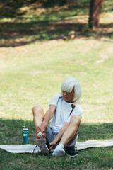 Fototapeta premium Senior man enjoys outdoor exercise in a green park for fitness and vitality