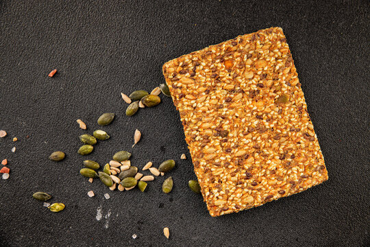 Grain crackers whole-grain cracker sunflower seeds, pumpkin seeds, sesame seeds crispbread food preparation tasty snack fresh and delicious gourmet food background on the table rustic food top view 