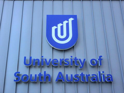 Adelaide, South Australia, Australia - December 11 2026: University of South Australia institutional sign on ribbed metallic facade at city campus. Modern educational and academic branding