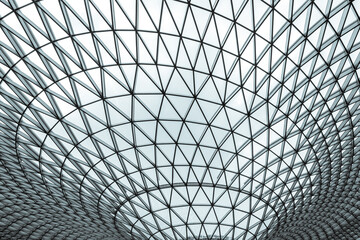 Modern glass and steel geometric dome roof with triangular pattern, futuristic architectural structure, abstract symmetry background for engineering, construction, innovation and technology design. © Fahroni