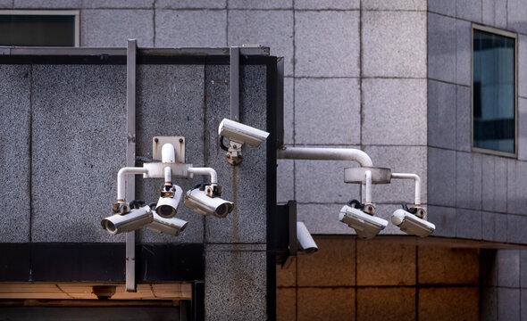 Multiple CCTV security cameras monitoring city building for public safety, surveillance technology and smart urban security system. Crime prevention, video monitoring and urban security infrastructure