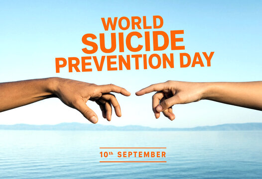 World suicide prevention day concept with two hands reaching out over water and sky background