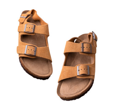 Cut out brown leather summer sandals with cork soles isolated on white background. Shoe mockup, fashionable unisex sandals, object for design and advertising. With clipping path. Mockup