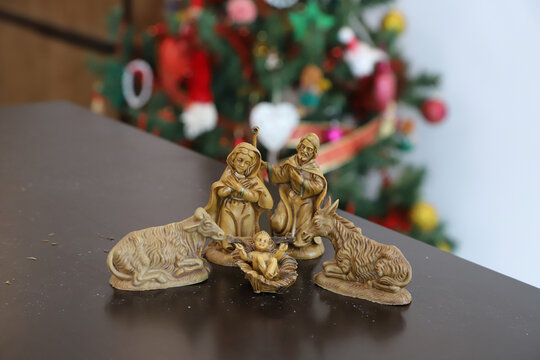 Traditional Christmas Nativity Scene with Holy Family in rustic wooden stable