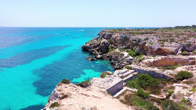 Favignana island coastline, Italy, with boats enjoying the turquoise water. Sicily, Italy