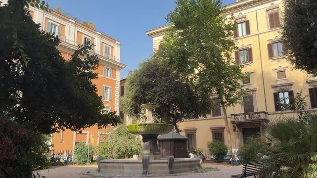 Charming urban square in Rome with a classic stone fountain, historic buildings, lush greenery, and peaceful morning light, capturing the authentic atmosphere of the Eternal City.