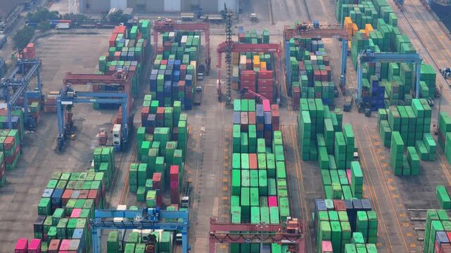 Jakarta, Indonesia - 18 July 2026: Aerial view of Port of Tanjung Priok showing rows of colorful shipping containers and large gantry cranes at the busy industrial terminal.
