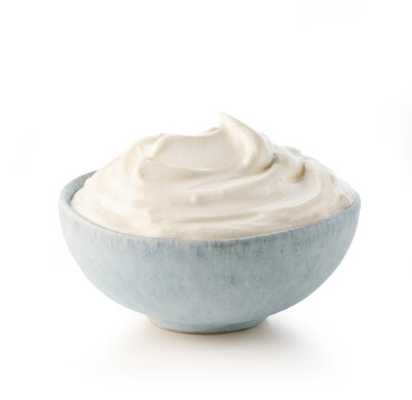 Light blue ceramic bowl of fresh sour cream or greek yogurt
