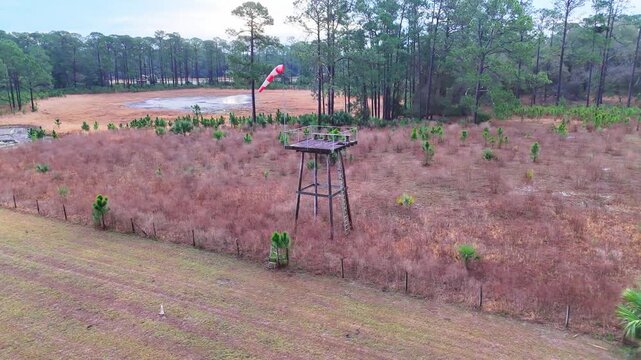 Lake County, Florida, United States - 21 July 2026: Aerial view of Crows Bluff observation tower in a field with a windsock and surrounding forest.