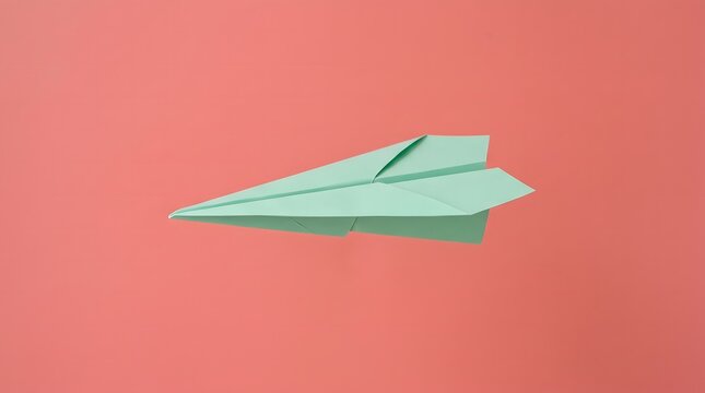 Green paper plane over coral background.