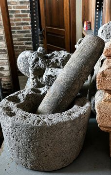 Ancient stone mortar and pestle on a workshop shelf