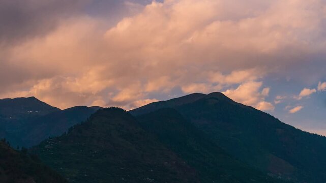 4K Timelapse of orange clouds moving above mountain range during sunset at Manali, Himachal Pradesh, India. Travel India. Nature landscape. Clouds and mountains time lapse.