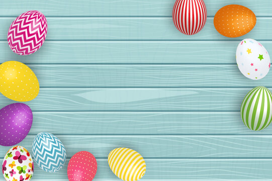 Colorful decorated easter eggs on a light blue woodgrain background springtime celebration