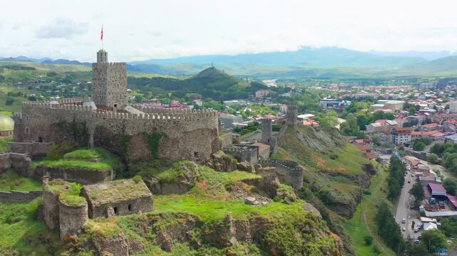 Rabati Fortress approaches in aerial view past stone battlements toward Akhaltsikhe city, supporting cultural tourism, conservation, historical education and regional destination promotion in Georgia.