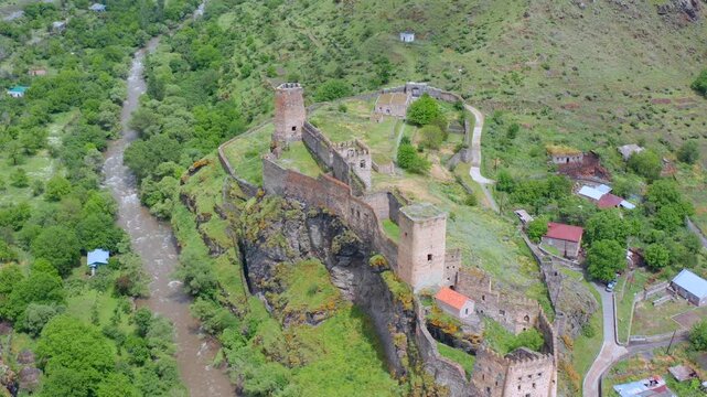 Khertvisi Fortress overlooks confluence, aerial view revealing medieval walls, towers and rocky terrain for Georgian heritage tourism, historical geography and destination promotion campaigns.