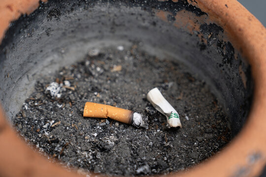 A close-up view of secondhand smoke, but lying on dirt.