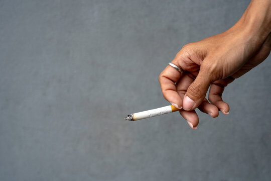 Woman's hand holding a cigarette.