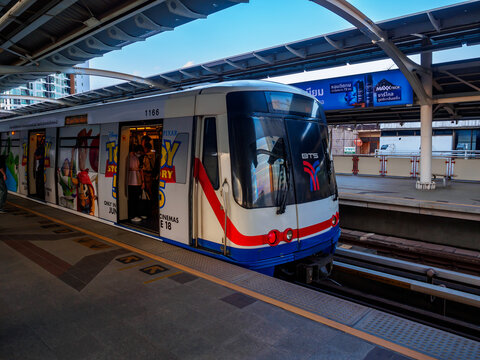 Bangkok, Thailand - July 8, 2026 : The BTS Skytrain runs in and out of Saphan Kwai Station in the afternoon, also offering views of Bangkok's beautiful office buildings.