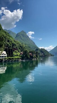 Scenic Lago di Lugano lakeside mountain scenery with old houses in summer