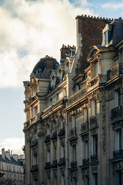 Ornate Haussmann-style residential building with wrought-iron balconies and sculpted limestone facade in the 17th arrondissement in Paris