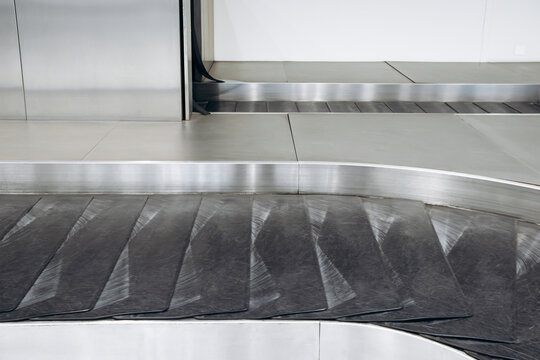 Close-up view of empty baggage conveyor belts in the baggage claim area