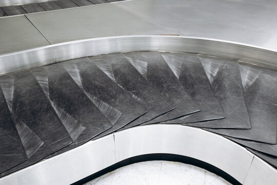 Close-up view of empty baggage conveyor belts in the baggage claim area