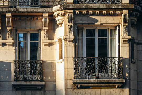 Haussmann-style residential building facade with ornate wrought-iron balconies on Rue Saint-Ferdinand in the 17th arrondissement.